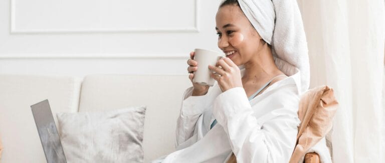 Midlife woman practicing self-care and wellness while reading about healthy living and finance.